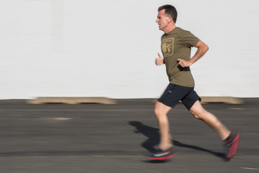 male athlete shown running with a motion blur